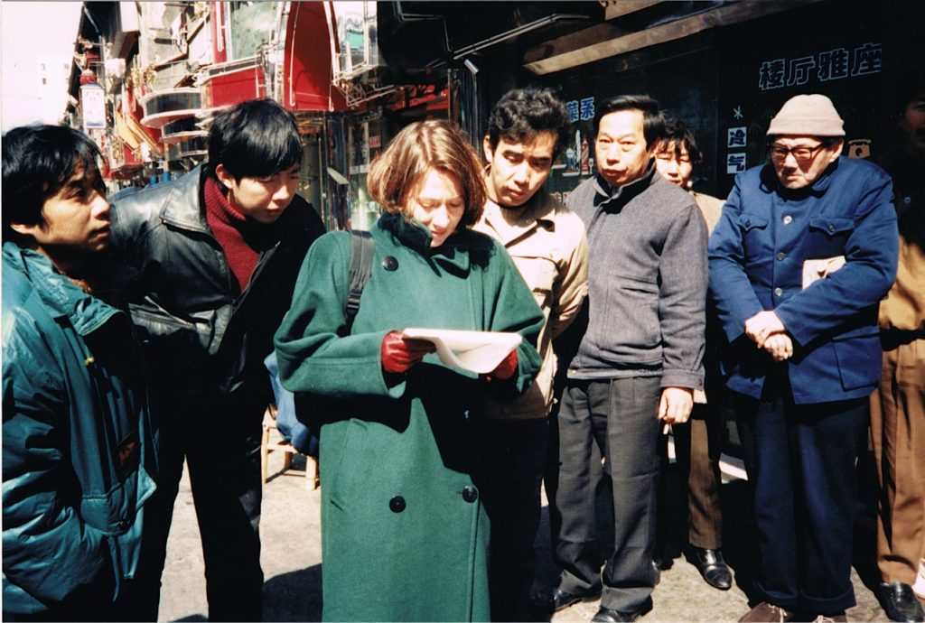 reporter looking at map in crowd